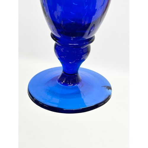 527 - An Early 20th Century Bristol Blue glass jug. 11x17.5cm.