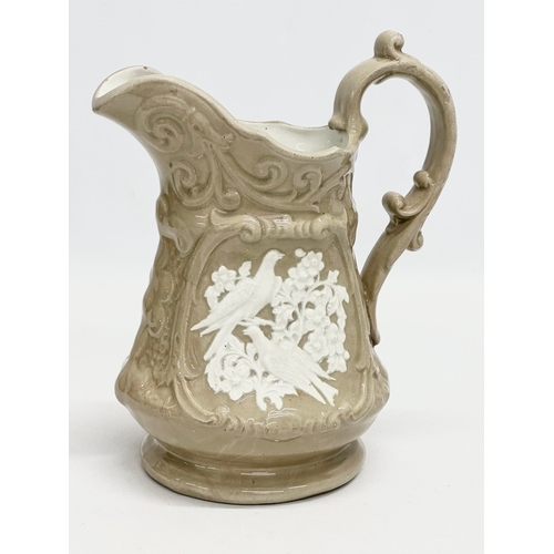 550 - A quantity of 19th Century pottery. A Mid 19th Century moulded relief jug 16x20cm. A glazed jug with... 