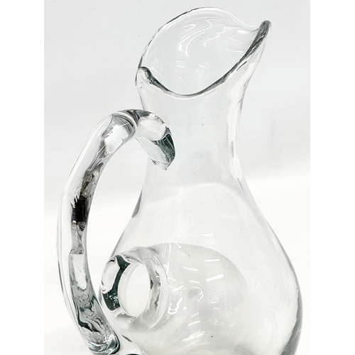 231 - An Early 20th Century French glass water jug with ice chamber. 19x27cm