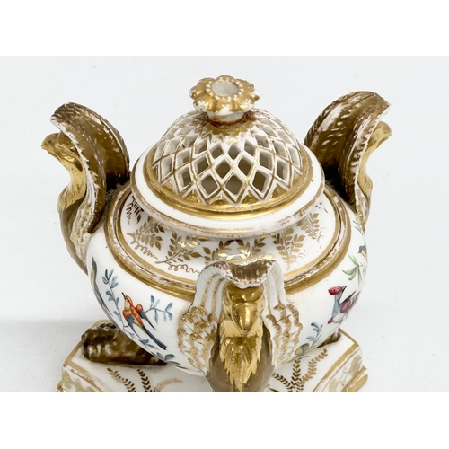 2 - An Early 19th Century gilt porcelain potpourri vase with cover. Raised on 3 griffins on a flat base,... 