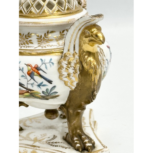 2 - An Early 19th Century gilt porcelain potpourri vase with cover. Raised on 3 griffins on a flat base,... 