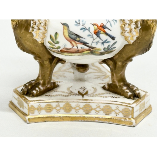 2 - An Early 19th Century gilt porcelain potpourri vase with cover. Raised on 3 griffins on a flat base,... 