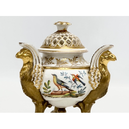 2 - An Early 19th Century gilt porcelain potpourri vase with cover. Raised on 3 griffins on a flat base,... 