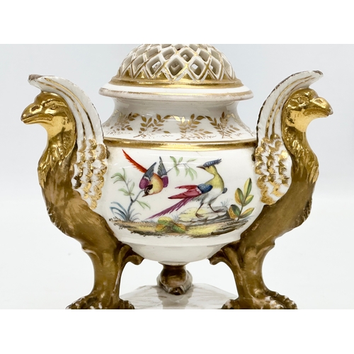 2 - An Early 19th Century gilt porcelain potpourri vase with cover. Raised on 3 griffins on a flat base,... 