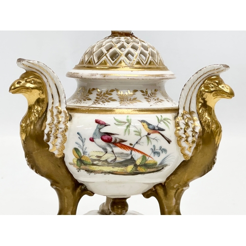 2 - An Early 19th Century gilt porcelain potpourri vase with cover. Raised on 3 griffins on a flat base,... 