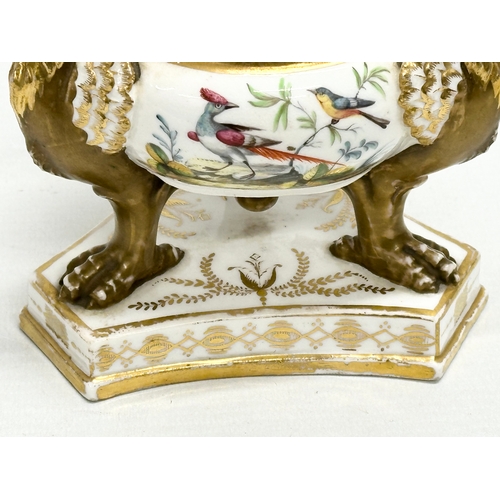 2 - An Early 19th Century gilt porcelain potpourri vase with cover. Raised on 3 griffins on a flat base,... 