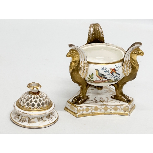 2 - An Early 19th Century gilt porcelain potpourri vase with cover. Raised on 3 griffins on a flat base,... 