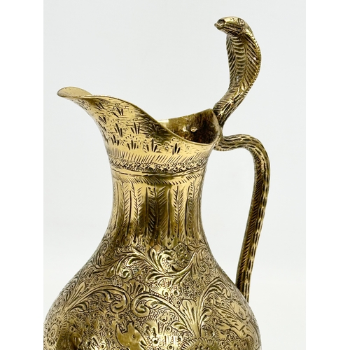 194 - An 18th/Early 19th Century Indian engraved brass ewer. Mughal Empire. 28cm