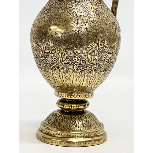 194 - An 18th/Early 19th Century Indian engraved brass ewer. Mughal Empire. 28cm