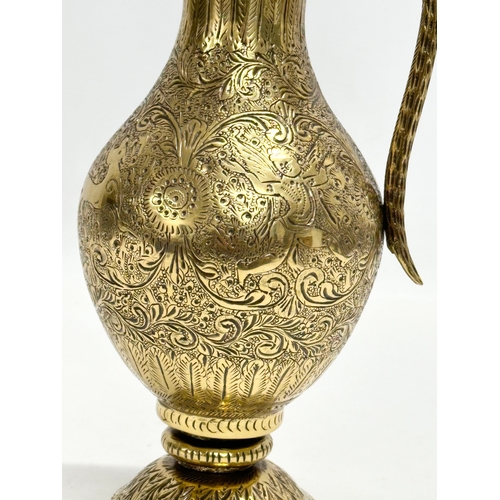 194 - An 18th/Early 19th Century Indian engraved brass ewer. Mughal Empire. 28cm