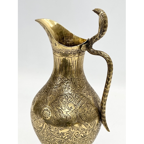 194 - An 18th/Early 19th Century Indian engraved brass ewer. Mughal Empire. 28cm