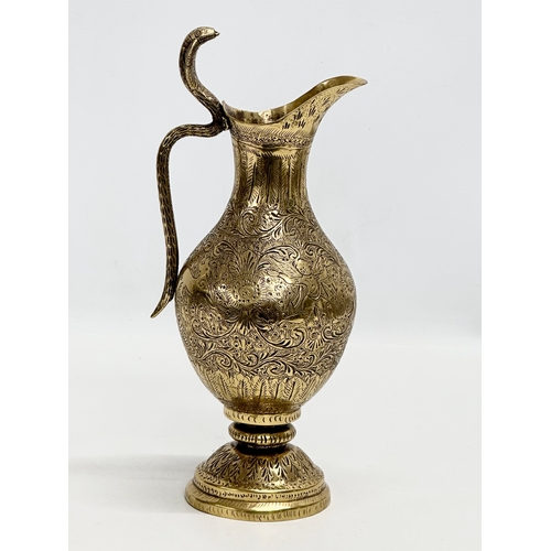 194 - An 18th/Early 19th Century Indian engraved brass ewer. Mughal Empire. 28cm