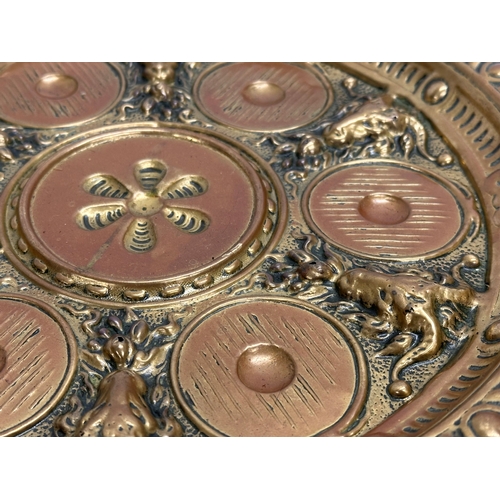 234 - A Late 19th/Early 20th Century brass serving tray with embossed rams heads and sunburst centre. 28cm