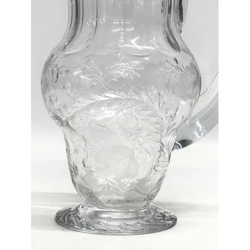 235 - Webb Crystal. A good quality Mid 20th Century glass water jug with engraved ferns and flowers. Marke... 