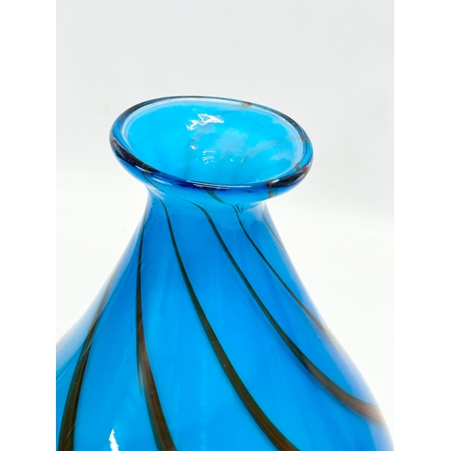 334 - A heavy art glass vase. With coloured swirls on a blue ground. 17x24cm.