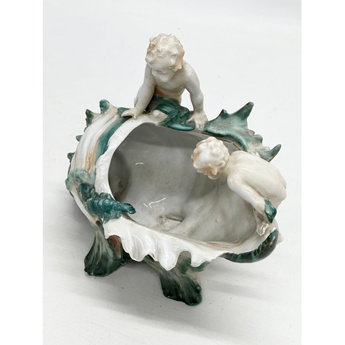 236 - A Late 19th/Early 20th Century lustre conch shell bowl, with 2 playing putti’s and lobster. 22x14x18... 