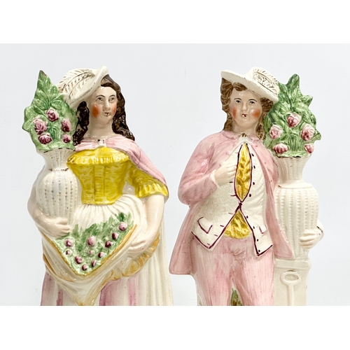 426 - A pair of 19th Century Victorian Staffordshire Pottery figures. 31cm