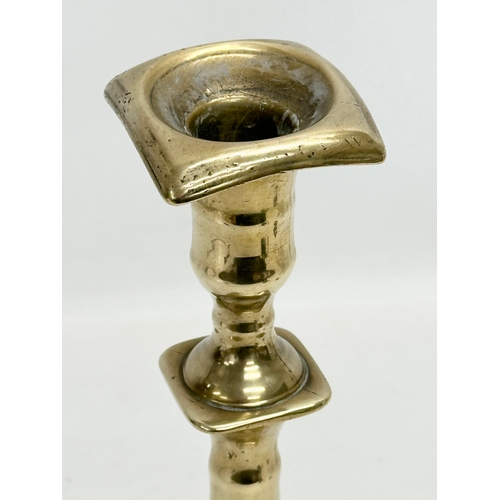 132 - An Early 18th Century George I brass candlestick. Circa 1714-1727. 27cm