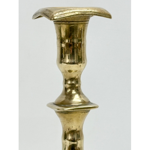 132 - An Early 18th Century George I brass candlestick. Circa 1714-1727. 27cm