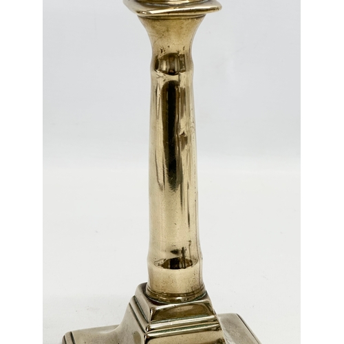 132 - An Early 18th Century George I brass candlestick. Circa 1714-1727. 27cm