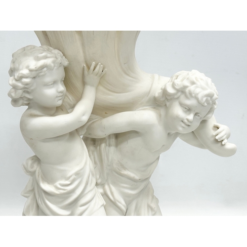 391 - A Late 19th/Early 20th Century Parian Ware blanc de chine centrepiece. Depicting 2 putti’s holding a... 