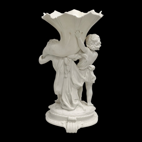 391 - A Late 19th/Early 20th Century Parian Ware blanc de chine centrepiece. Depicting 2 putti’s holding a... 