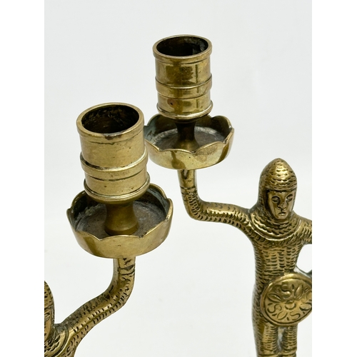 392 - A pair of 19th Century Victorian Medieval Revival brass candlesticks. 22cm.