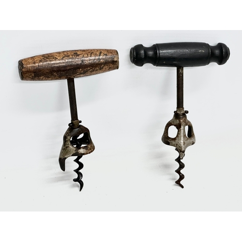 505 - Three 19th Century brass corkscrews with turned wooden handles. 1 with coat of arms.