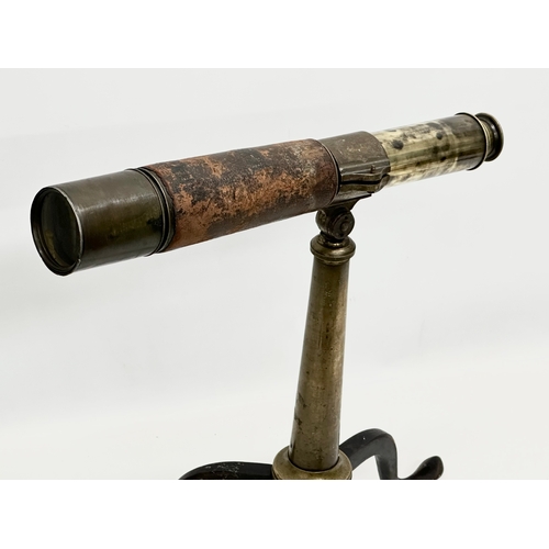 41 - Watson & Sons. A 19th Century 5 draw brass and leather bound telescope on a brass and iron tripod ba... 