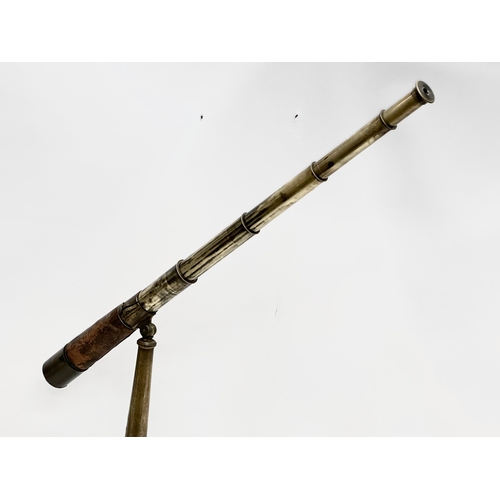 41 - Watson & Sons. A 19th Century 5 draw brass and leather bound telescope on a brass and iron tripod ba... 