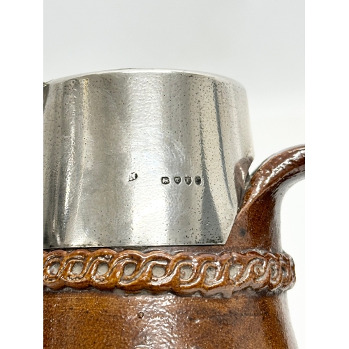 574 - Silver mounted. A Late 19th Century Lambeth jug, with London mark and Prince of Wales Feathers. 15cm