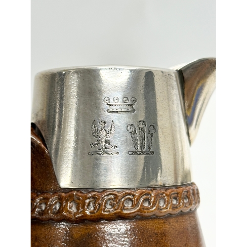 574 - Silver mounted. A Late 19th Century Lambeth jug, with London mark and Prince of Wales Feathers. 15cm