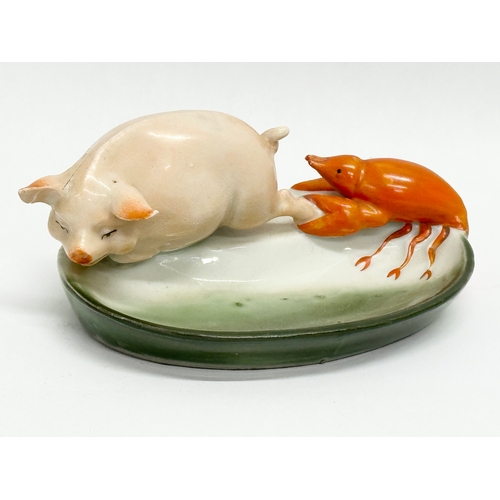 807 - 2 pieces of Early 20th Century German pottery. A pig and lobster pin dish 14cm. A pottery salt 7cm.