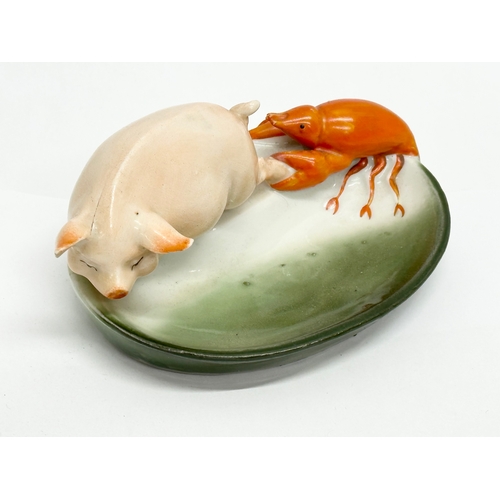 807 - 2 pieces of Early 20th Century German pottery. A pig and lobster pin dish 14cm. A pottery salt 7cm.