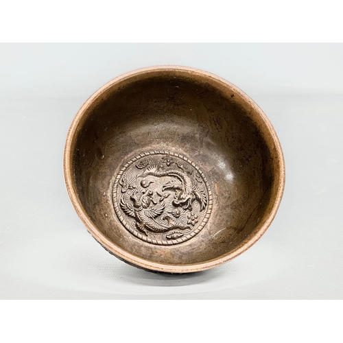 210 - A Chinese bronze bowl. With Xuande 4 character mark, dragons and koi fish interior, on a Greek Key b... 