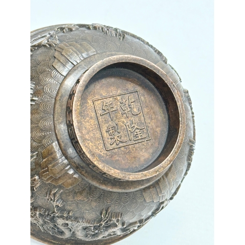 210 - A Chinese bronze bowl. With Xuande 4 character mark, dragons and koi fish interior, on a Greek Key b... 