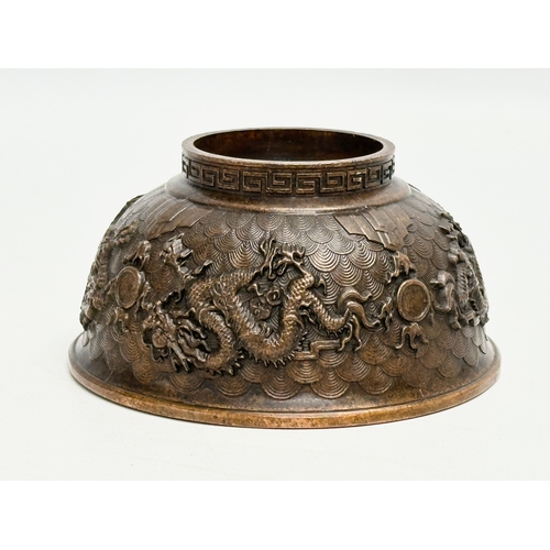 210 - A Chinese bronze bowl. With Xuande 4 character mark, dragons and koi fish interior, on a Greek Key b... 