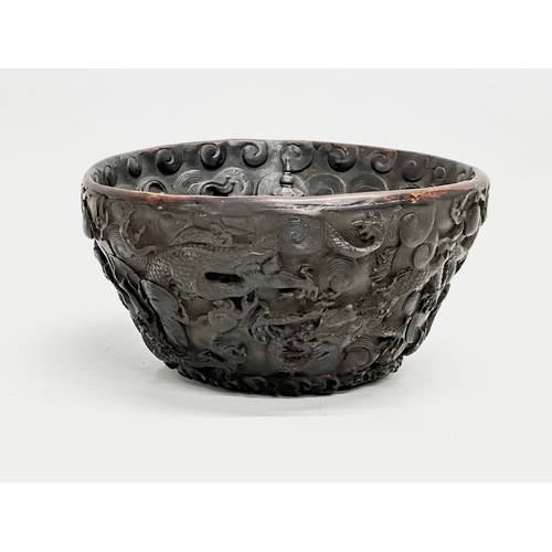 211 - A Chinese carved dragon and koi fish bowl. 20th Century. 15x8cm.