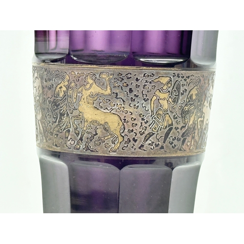 62 - Moser Karlsbad. A signed 1920’s Czech amethyst glass vase, with gilt panel depicting a mythical batt... 