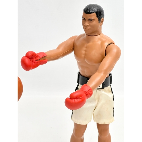 716 - A Denys Fisher Muhammad Ali figure with punch bag. 1976.