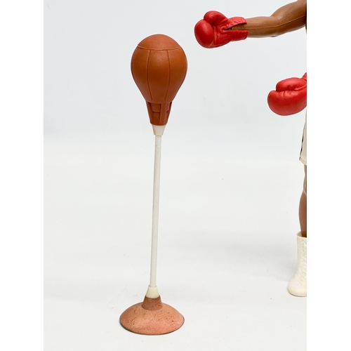 716 - A Denys Fisher Muhammad Ali figure with punch bag. 1976.