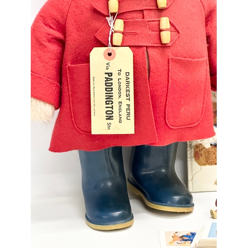 731 - Paddington Bear collectables. The Paddington Bear in red felt jacket, hat and Dunlop Wellington boot... 