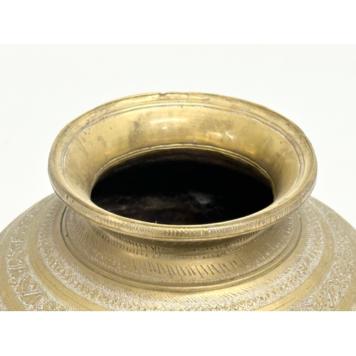 288 - A Late 19th Century Indian engraved brass jar with cover. 18x22cm.