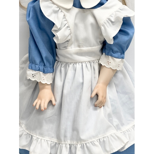 766 - A rare 1995 SCS/MDA Alice in Wonderland porcelain doll. Marked M. Ratcliffe. 62cm