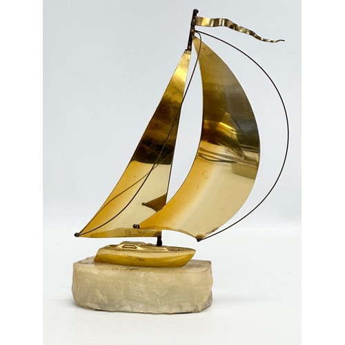 804 - John & Don Demott. 2 signed brass and onyx yachts. 24cm. 23cm.