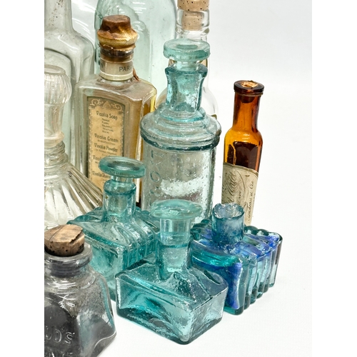 523 - A large collection of 19th and 20th Century glass bottles and jars. Chemist, ink, whiskey etc.