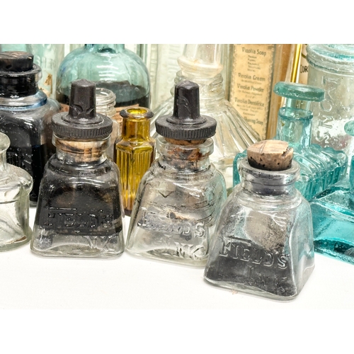 523 - A large collection of 19th and 20th Century glass bottles and jars. Chemist, ink, whiskey etc.