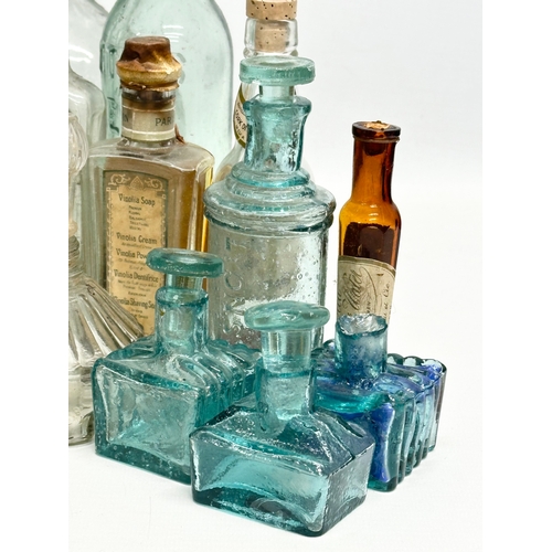 523 - A large collection of 19th and 20th Century glass bottles and jars. Chemist, ink, whiskey etc.