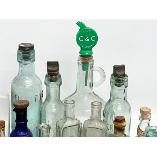 523 - A large collection of 19th and 20th Century glass bottles and jars. Chemist, ink, whiskey etc.