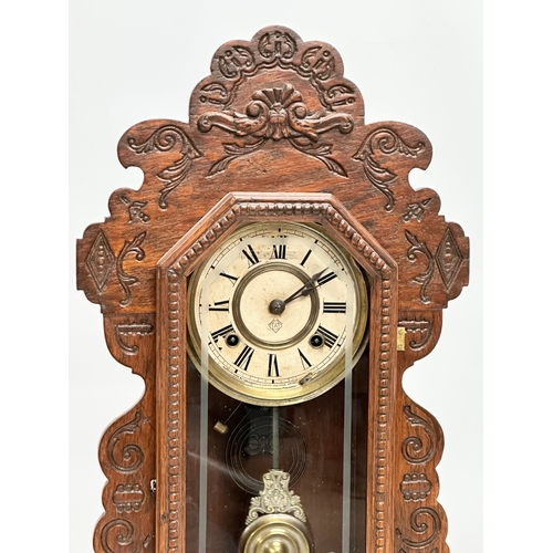 799 - A Late 19th Century American Gingerbread clock. Arsonia. With key and pendulum. 36x13x58cm